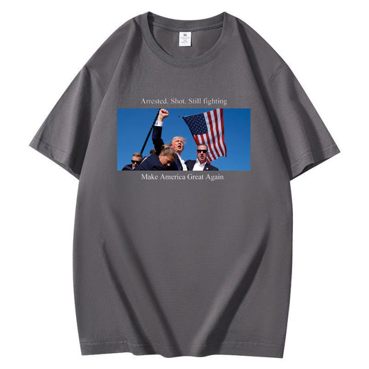 Trump being rushed off while pumping his fist after being shot in the ear at his rally shirt